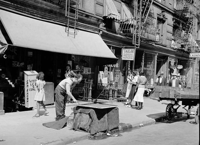 Iceman with large cake of ice, 1939.