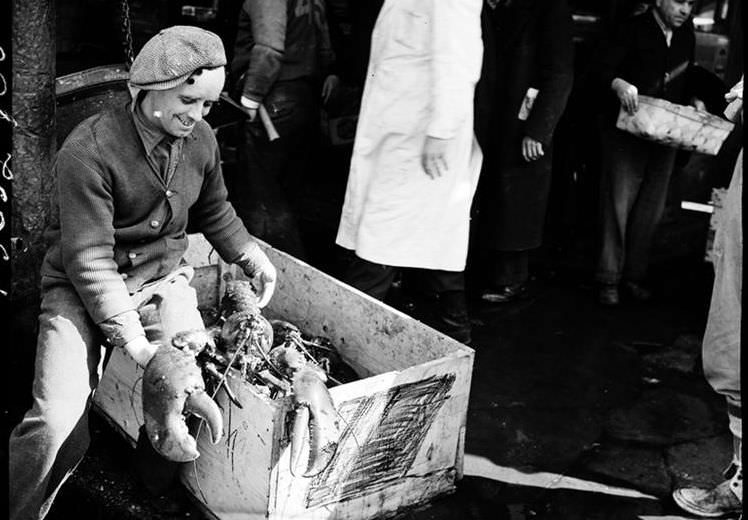 Fulton Street Market: man with lobster, 1938.