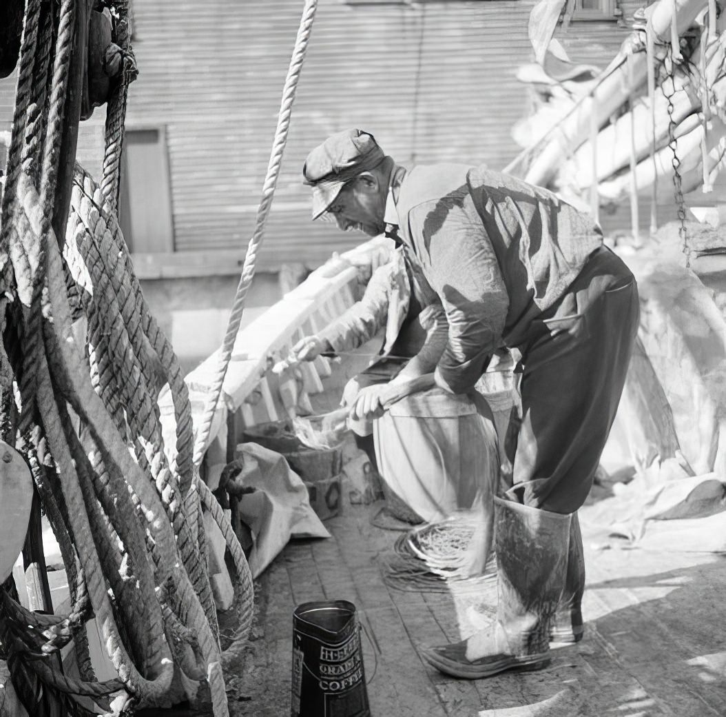 Waterfront scene: man working on deck, May 1938.