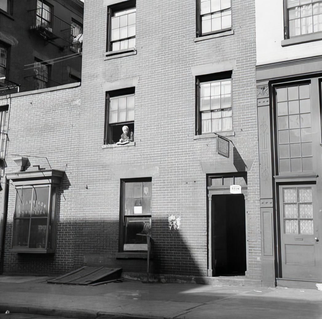 Tenement with a person in the window, 1935.