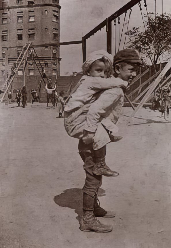 A child riding on another child's back, 1895.