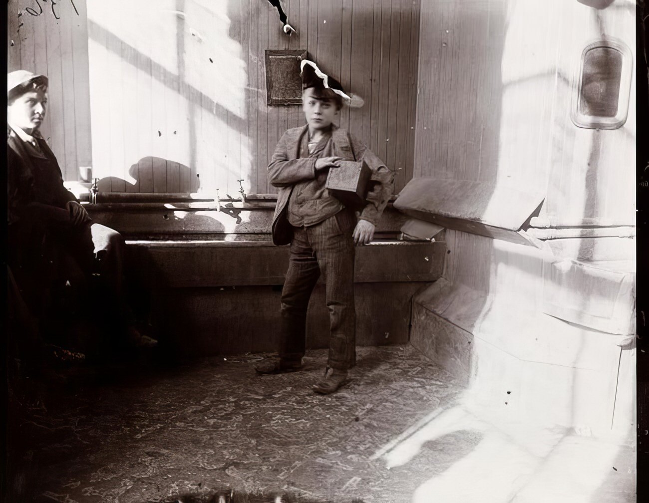 A bootblack posing at 9 Duane Street, 1891.