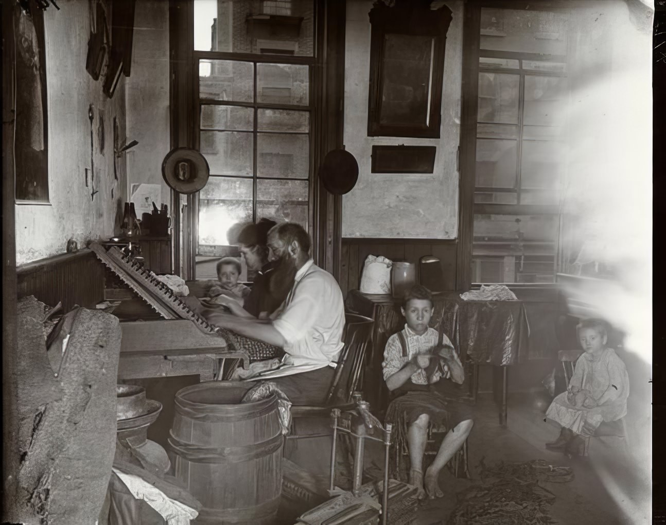 Bohemian cigar makers at work in their tenement, 1891.