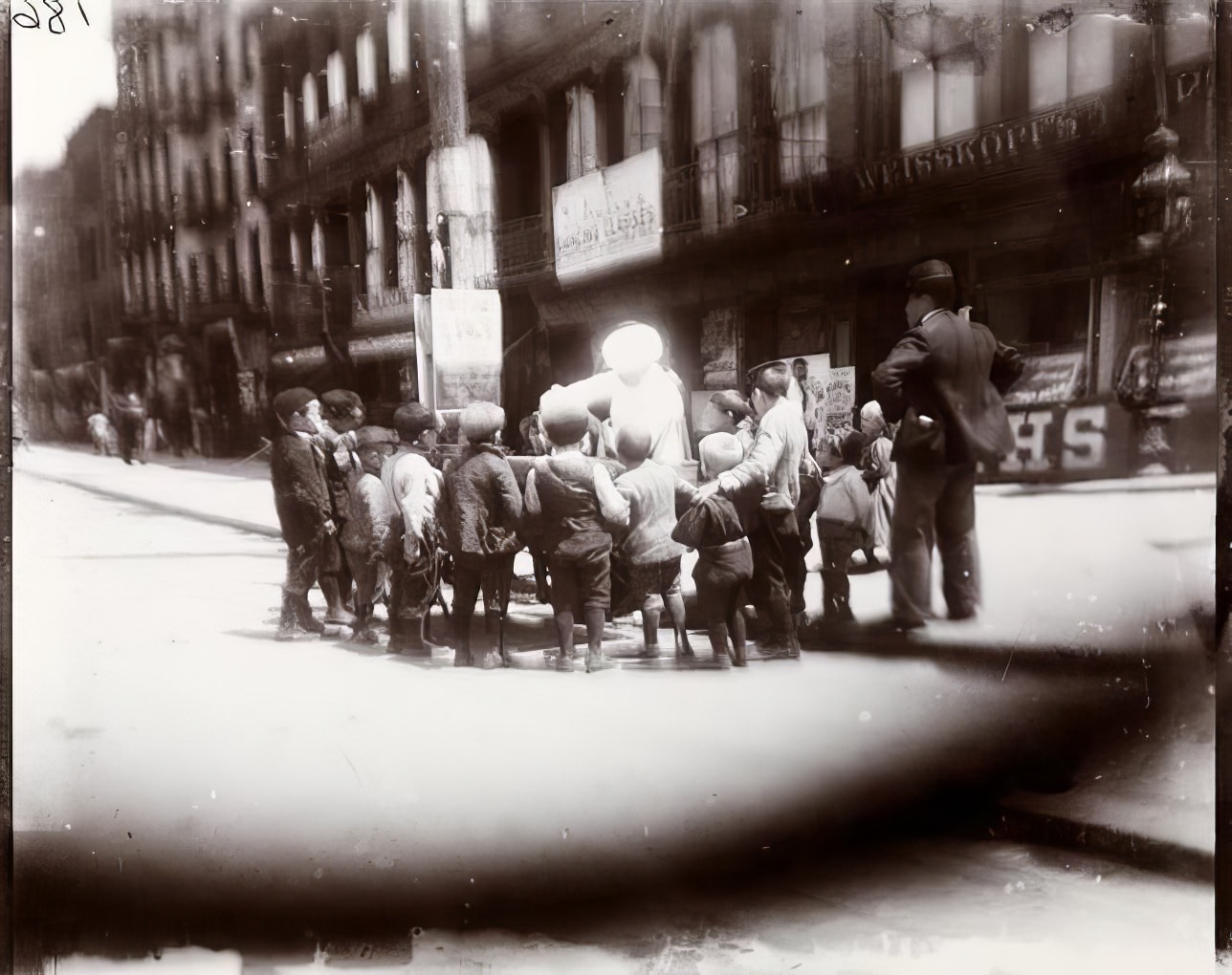 Watching a hokey-pokey man on First Avenue, 1891.