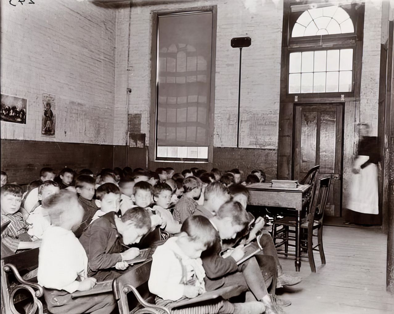 A class without desks in the Essex Market School, 1891.