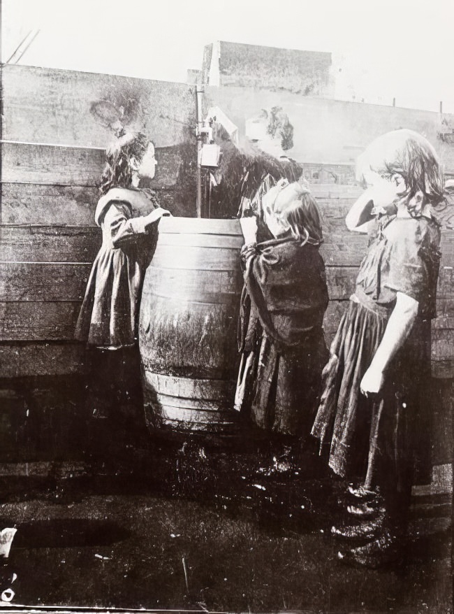 A boy hiding from a police officer in a West Side playground, 1895.