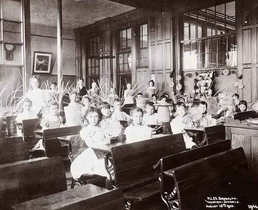 Children participating in basket-weaving in vacation school, 1894.