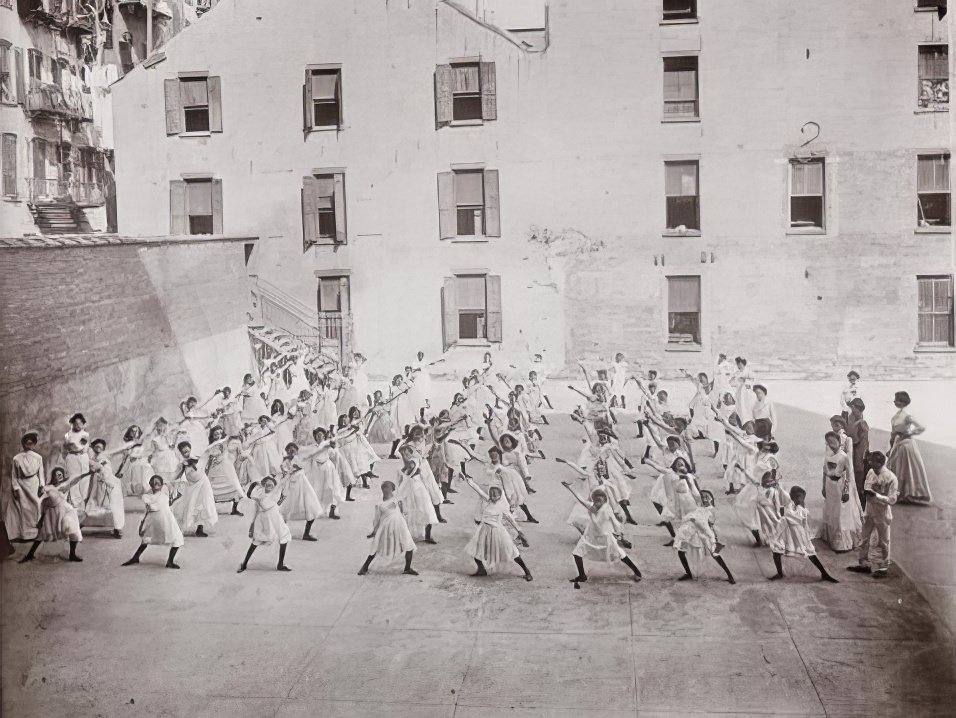 Dumbbell exercises in a public school playground on Monroe and Market Streets, 1901.