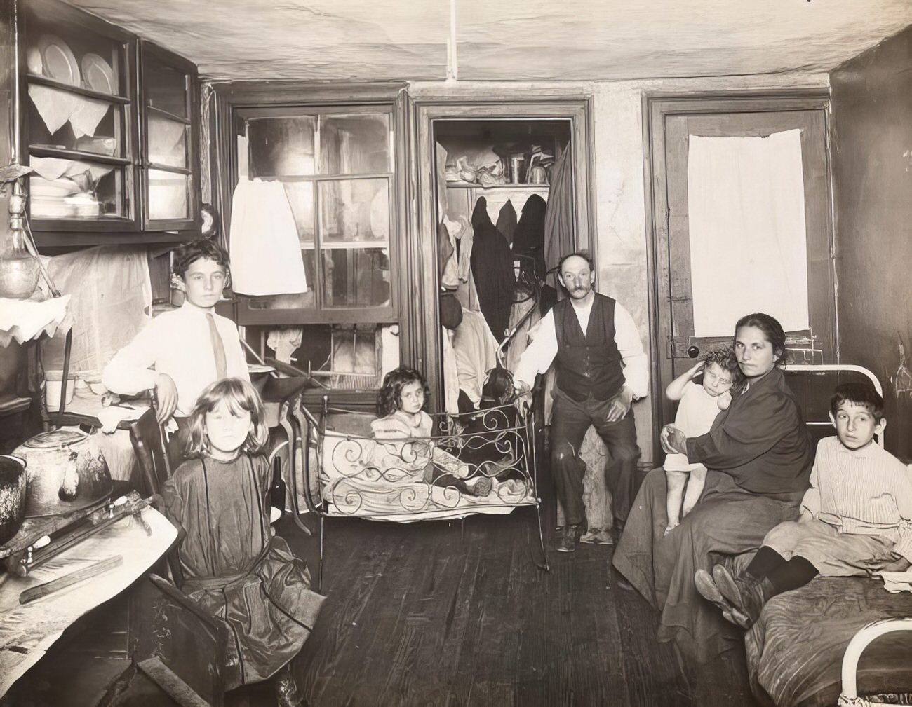 A family in a tenement house room, 1910s.