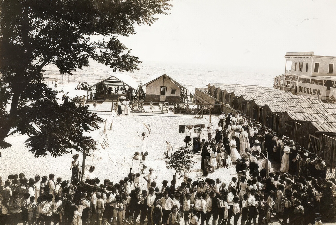 Children lining up on the beach, circa 1895.