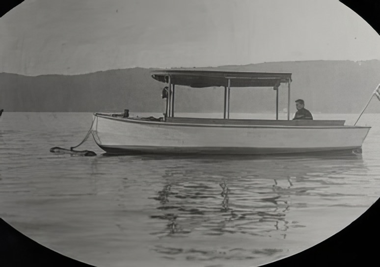 Small boat anchored in the lake, circa 1914.