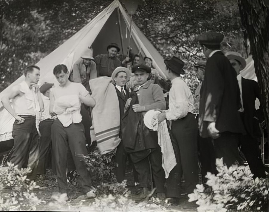 Group of men in front of tent, circa 1914.