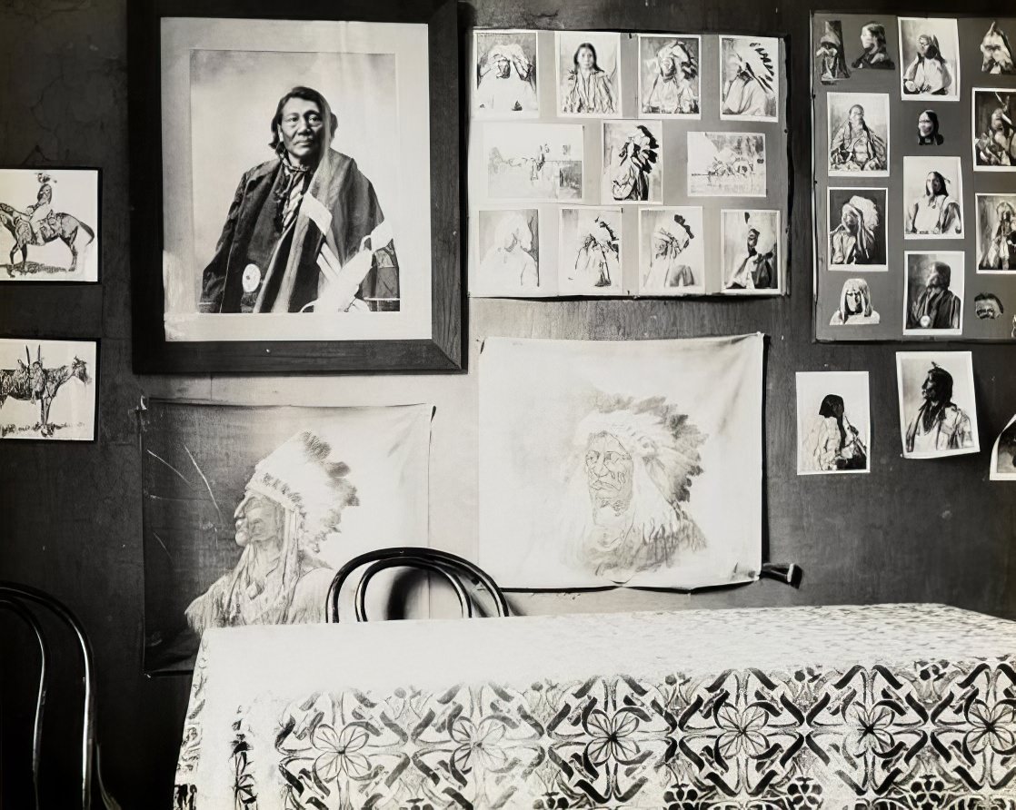 A wall of pictures of Native Americans, 1900.