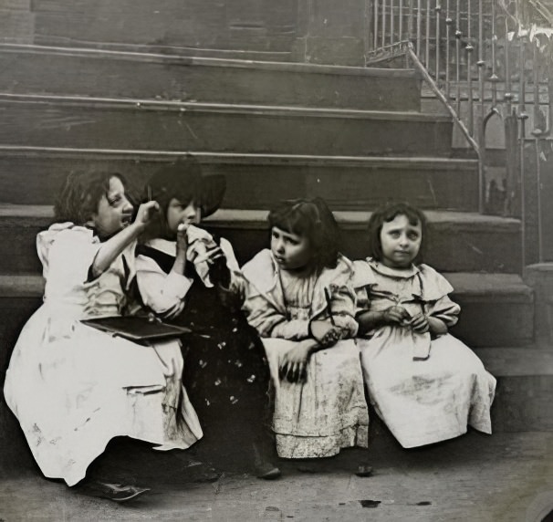 Four young girls on a stoop, 1900.