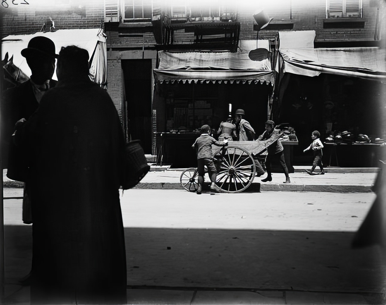 Boys playing in a street playground, 1890s.