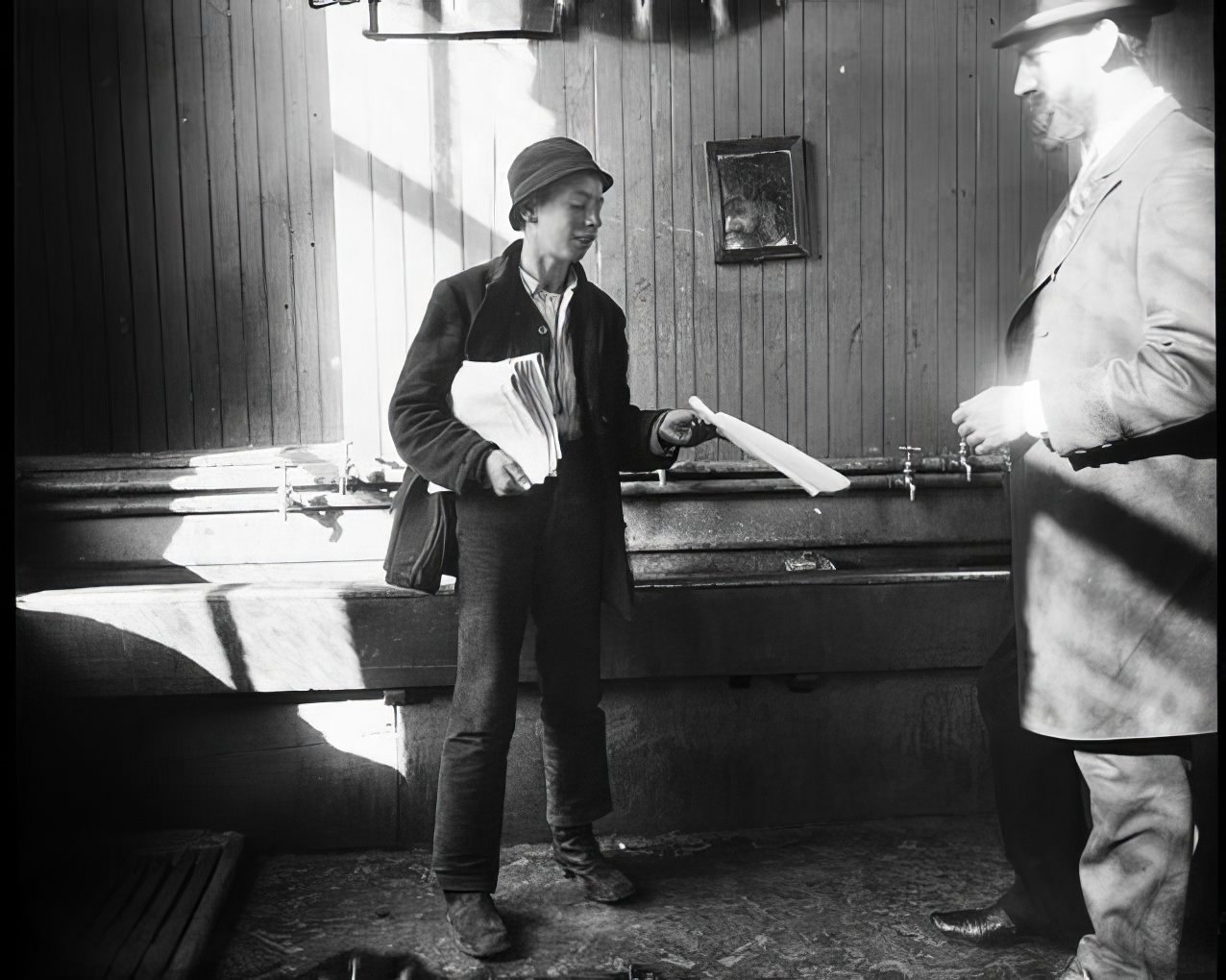 A newsboy in a lodging house, 1890s.