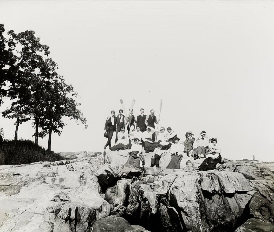 A group portrait by the water, 1900.