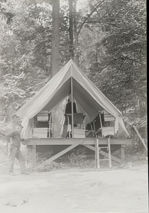 Pitched tent on platform and old man with a pipe, 1914.