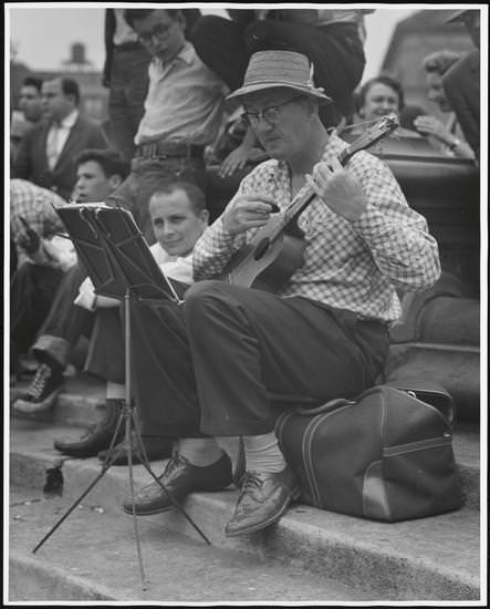 A man playing a ukulele in Washington Square Park, 1956.