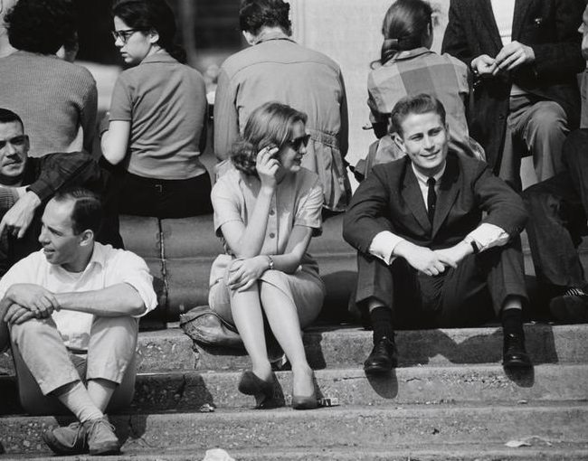 A man in a suit sitting on the fountain steps, Washington Square Park, 1956.