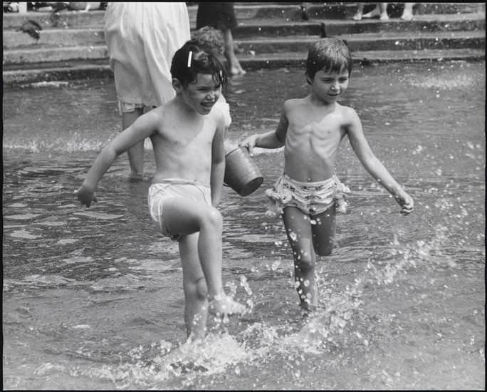 Two children splashing in the fountain in Washington Square Park, 1956.