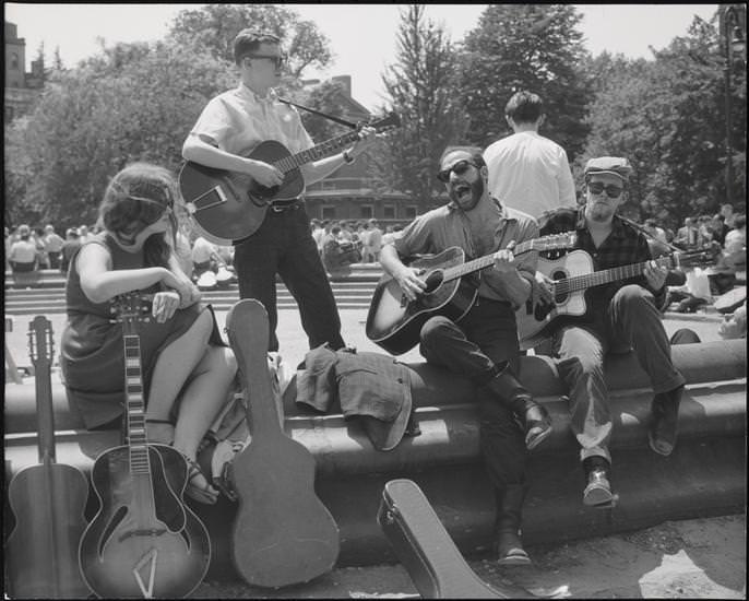 A bearded guitarist with other musicians in Washington Square Park, 1956.