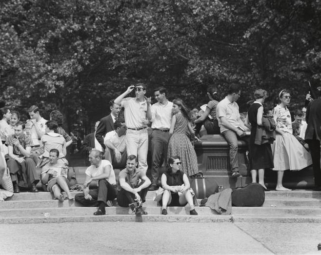 A man with a camera on the fountain steps, Washington Square Park, 1956.