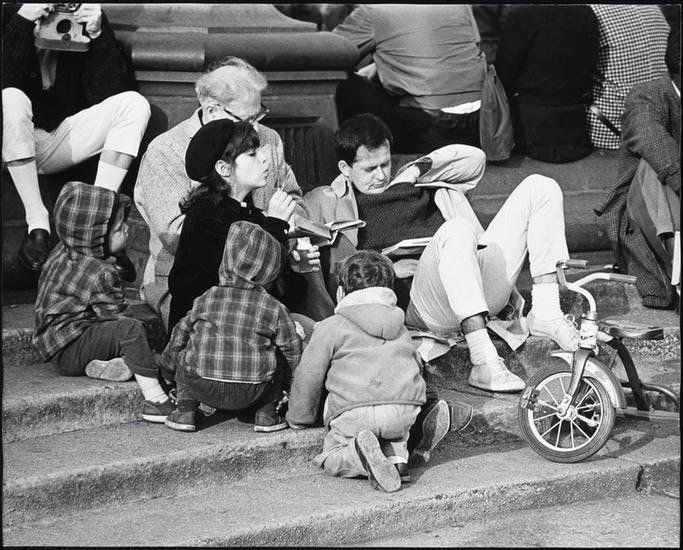 A woman in a beret blowing bubbles on the fountain steps, Washington Square Park, 1956.