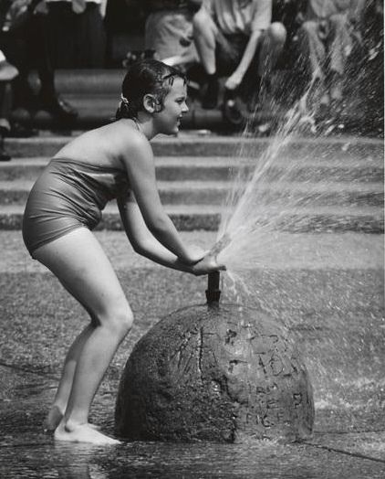 A young girl splashing in the fountain, Washington Square Park, 1956.