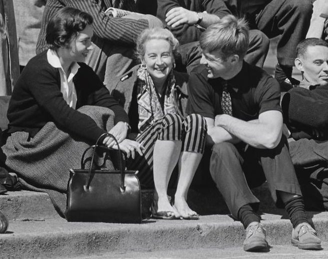 A man talking to two women on the fountain steps, Washington Square Park, 1956.