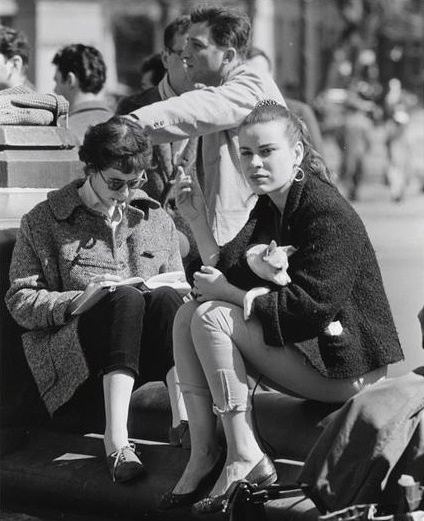 A girl holding a white dog, Washington Square Park, 1956.