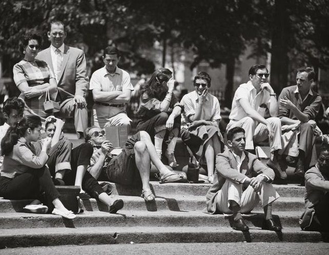 A crowd scene on the fountain steps, Washington Square Park, a man in sandals reading, 1956.