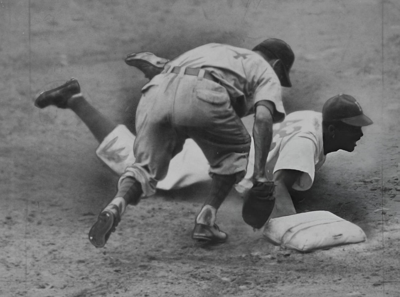 Jackie Robinson stealing second base, 1948.