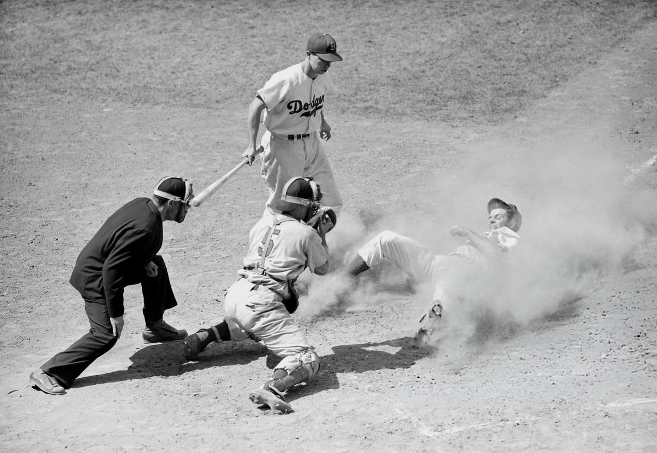 Miksis of the Dodgers stealing home, 1940s.