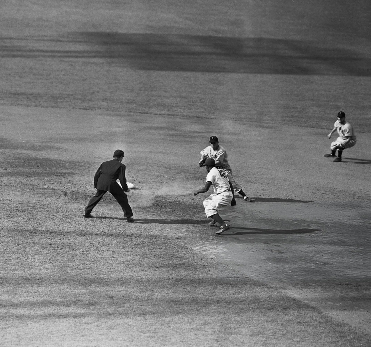 Jackie Robinson attempting to steal second, 1940s.