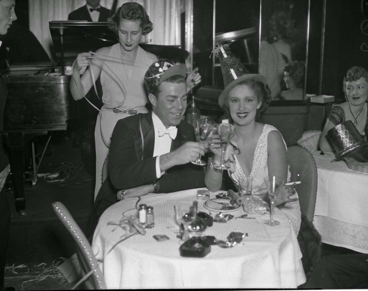 A couple toasting New Year's Eve at the Stork Club, New York City, 1930s.