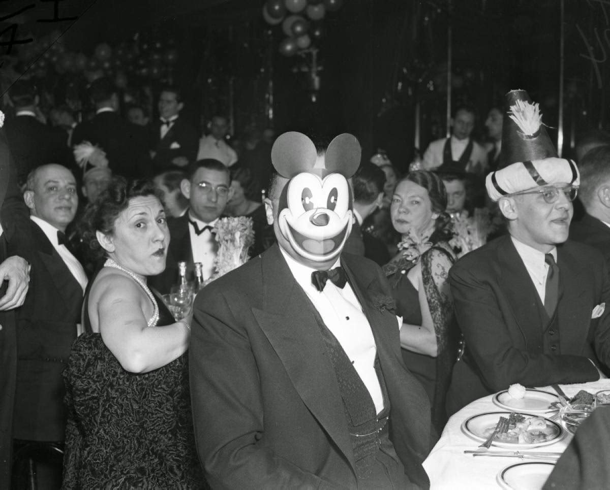 J. Edgar Hoover celebrating New Year's Eve in a Mickey Mouse mask, 1938.