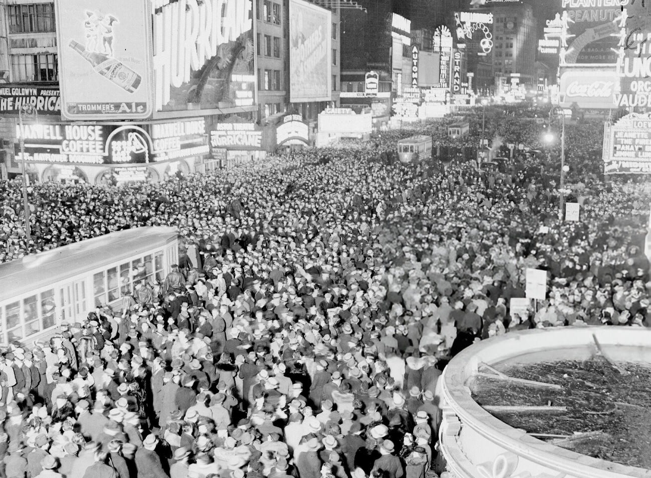 Times Square filled with people celebrating New Year's Eve, 1930s.