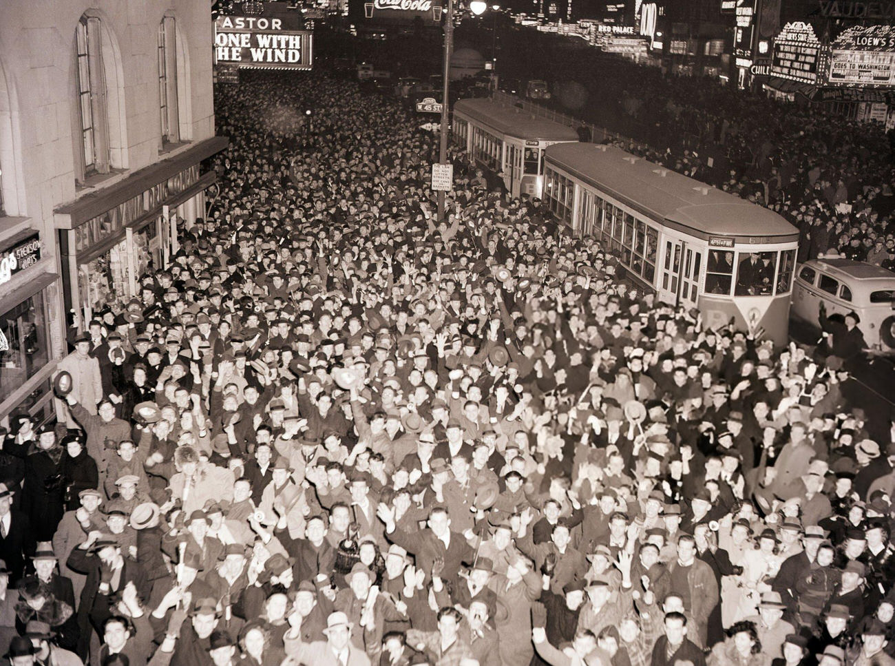 Crowd celebrating New Year's Eve outside the Hotel Astor in Times Square, New York City, 1939.