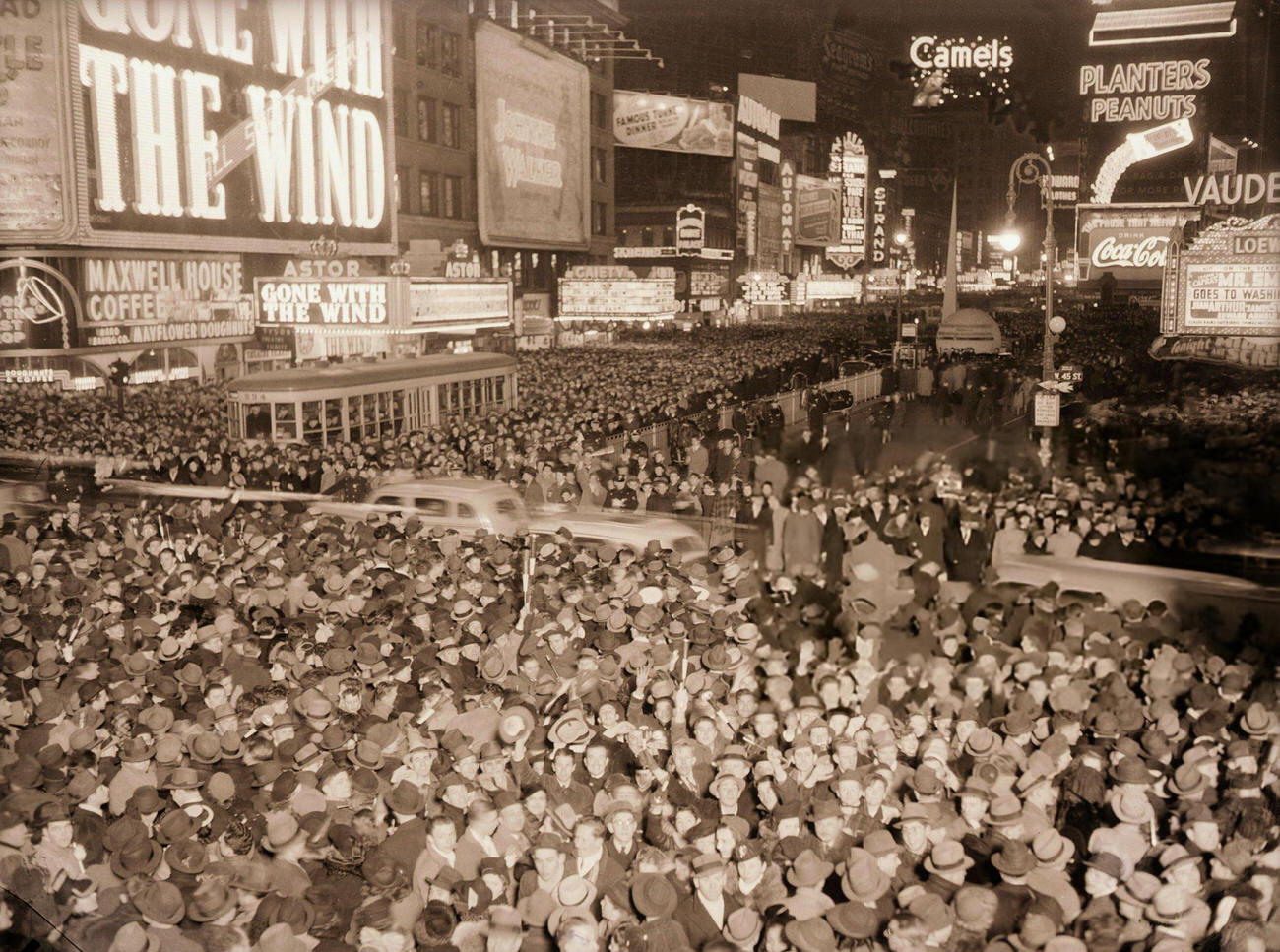 Crowd celebrating New Year's Eve in front of the Astor Hotel in Times Square, New York City, 1939.