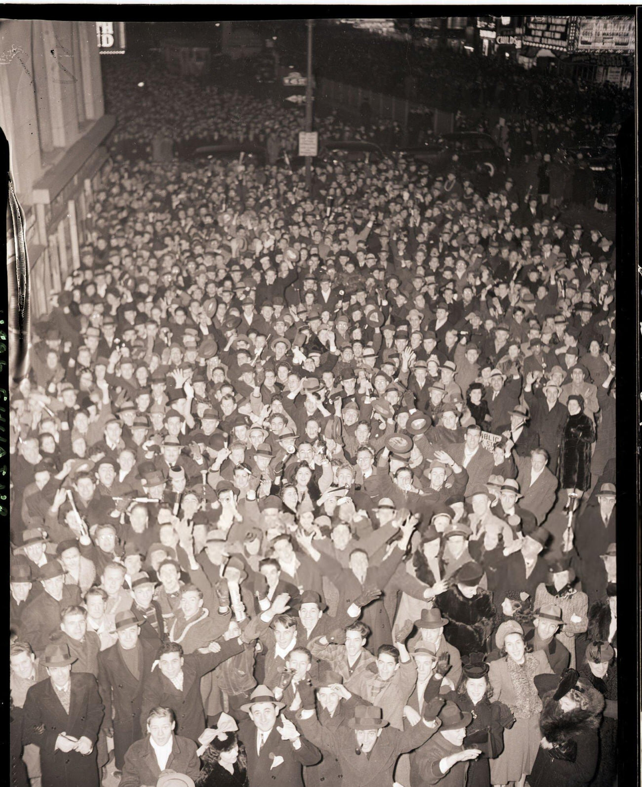 Crowd celebrating New Year's Eve in front of the Astor Hotel in Times Square, New York City, 1939.