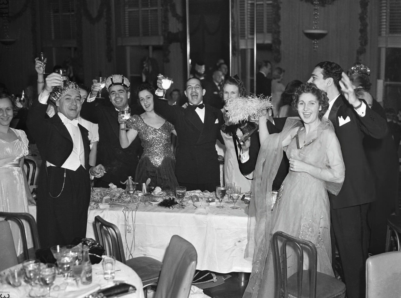 Crowd toasting at a New Year's celebration at the Rainbow Grill, New York City, 1940.