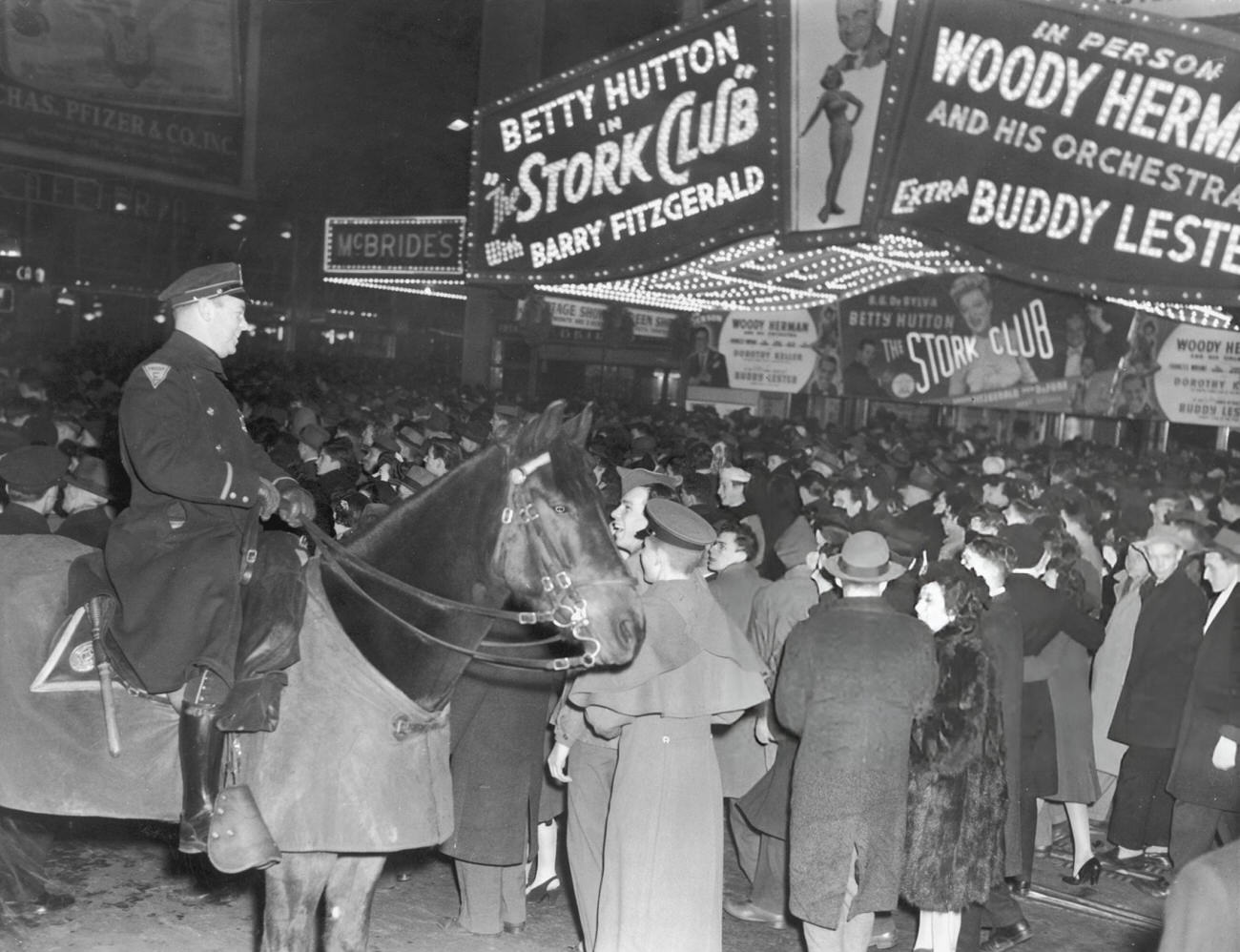 Crowds gathering on Broadway in Times Square on New Year's Eve, 1945.