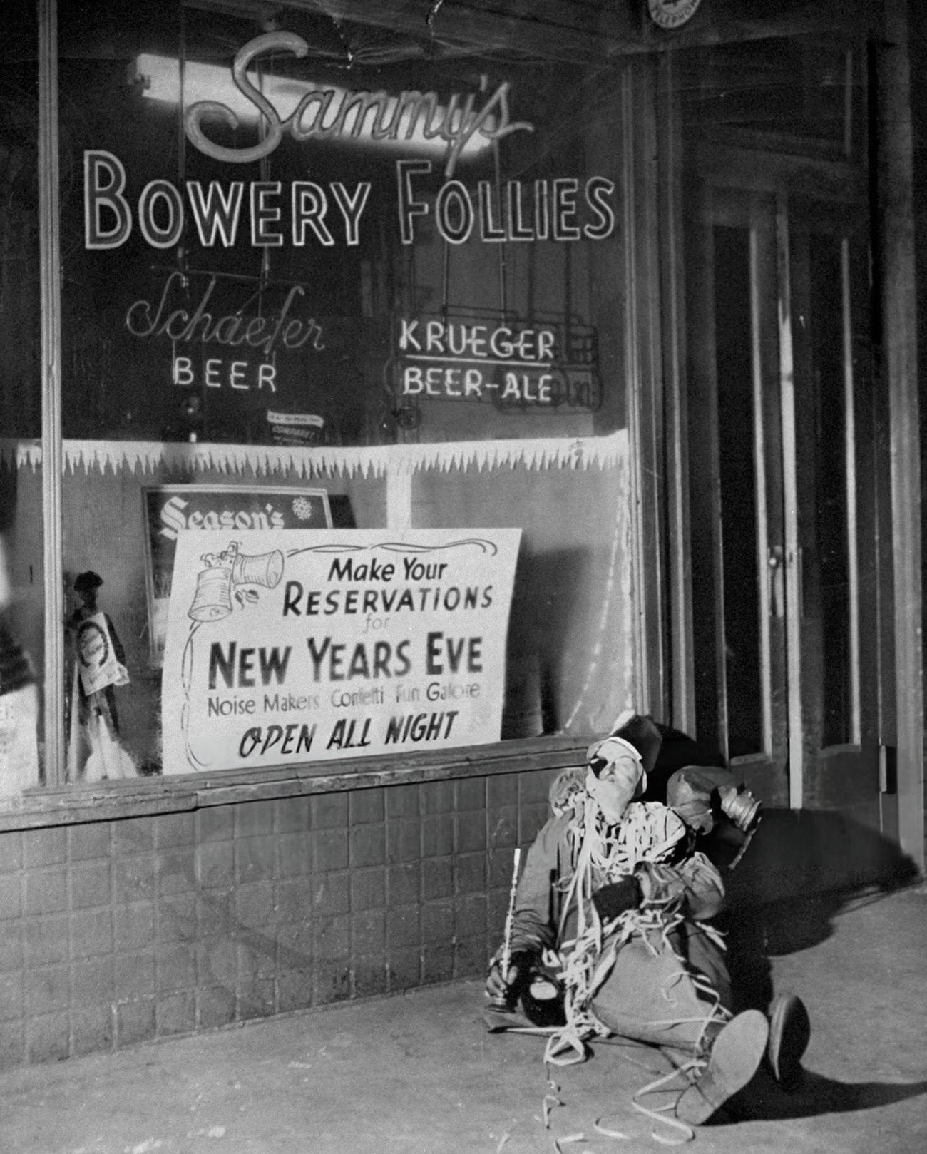 A man sitting outside the Bowery after being unable to get a seat at Sammy's Bowery Follies, New York City, 1940s.