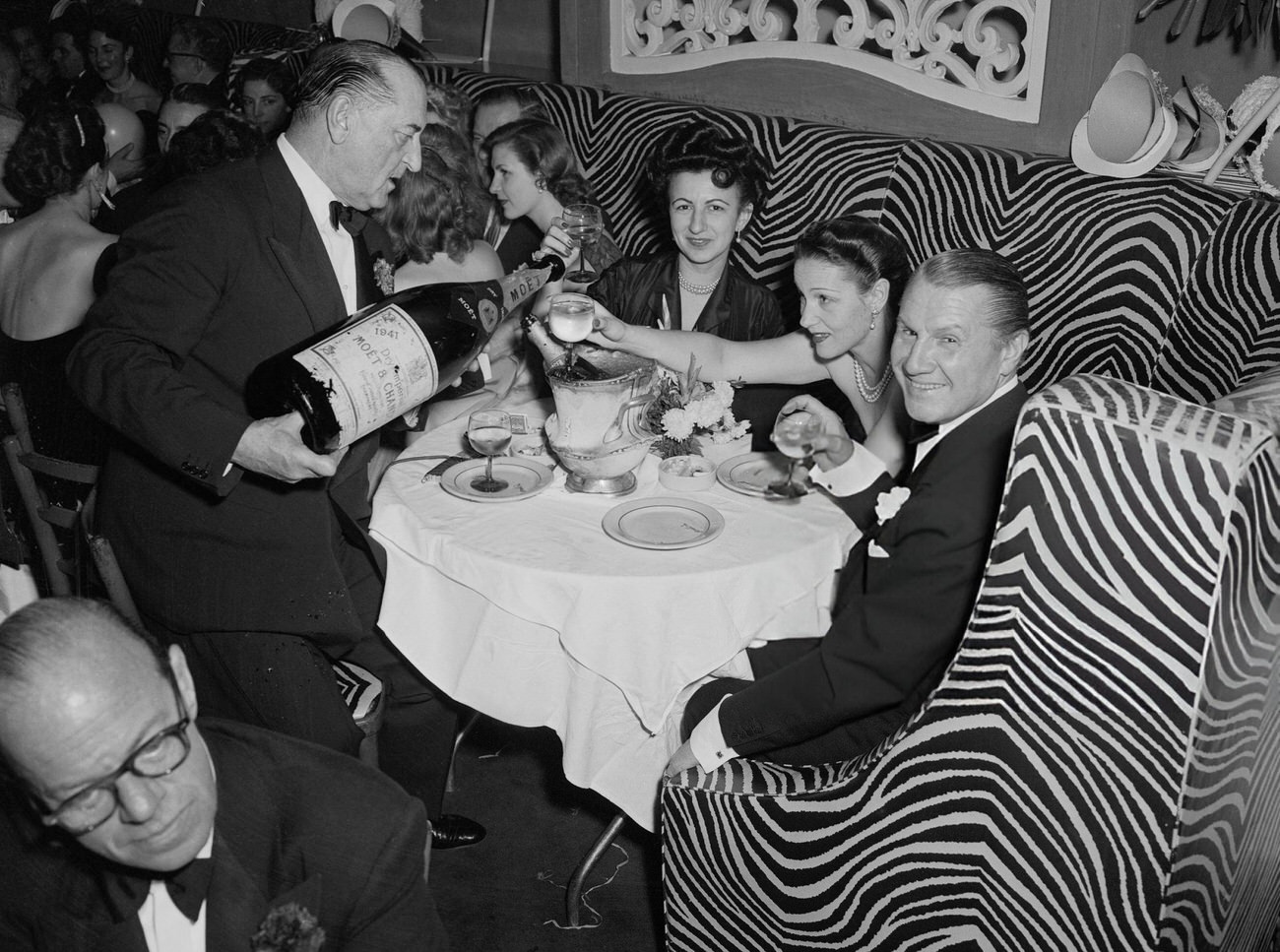 John Perona celebrating New Year's Eve with guests at El Morocco, New York City, 1950s.