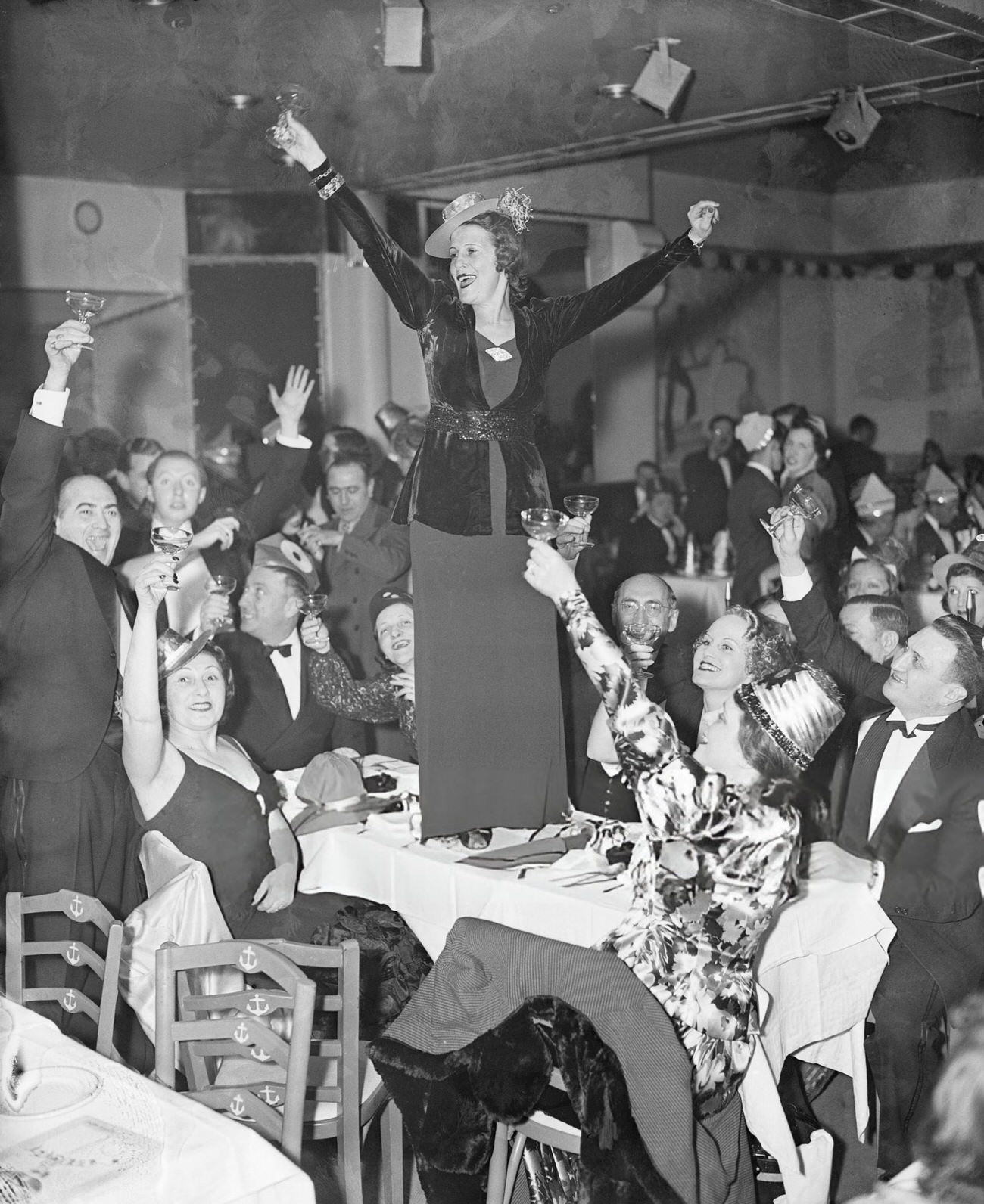 A woman toasting the New Year at a New York yacht club, 1930s.