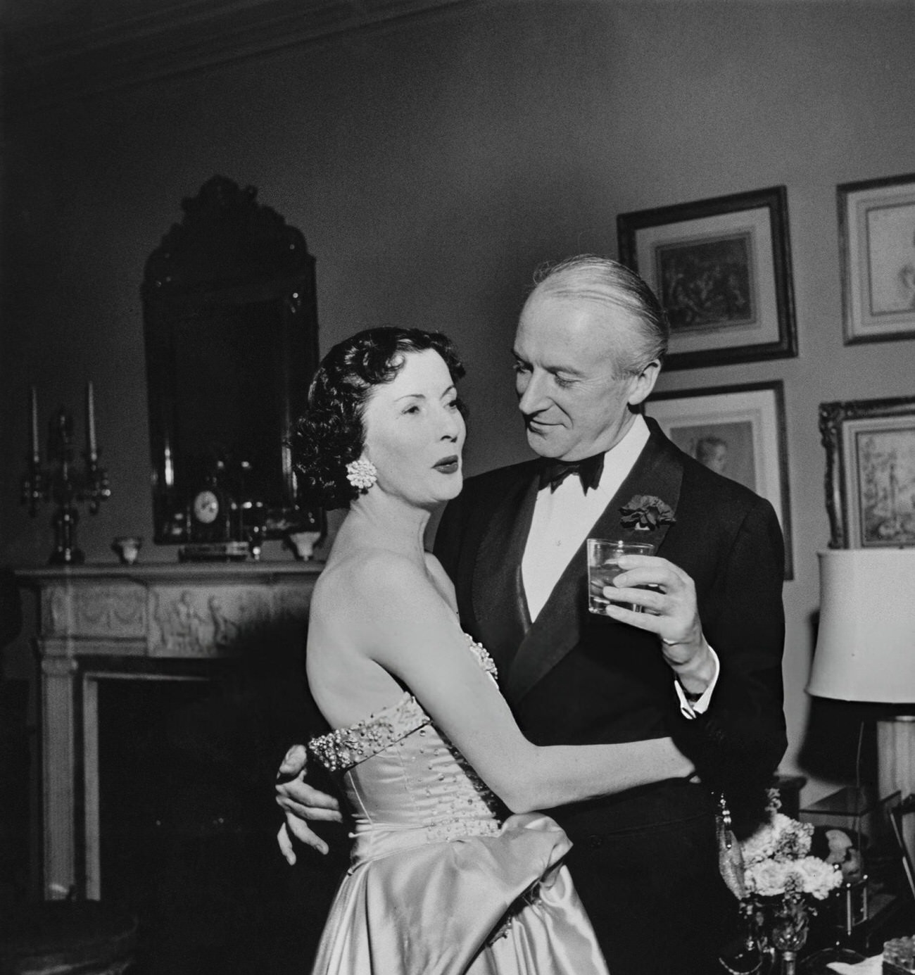 Cecil Beaton and Mrs. Julien Chaqueneau at Kitty Miller's New Year's Eve party, New York City, 1952.