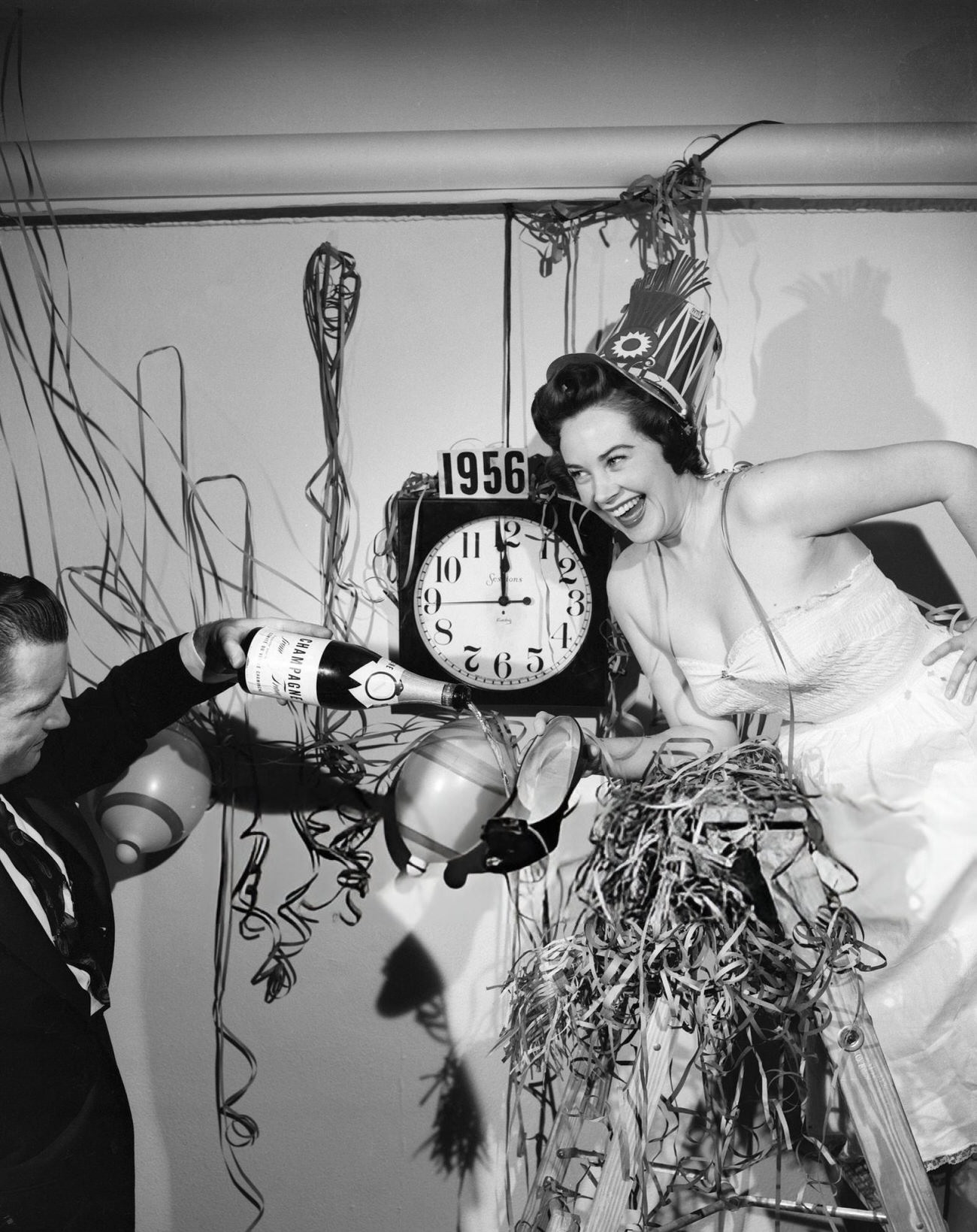 Dorothy Rowand toasting the New Year with champagne, New York City, 1955.