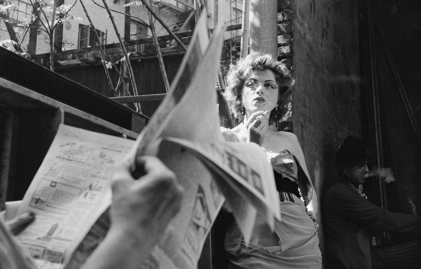 An unidentified actress smokes a cigarette outside a theatre in Greenwich Village, 1954.