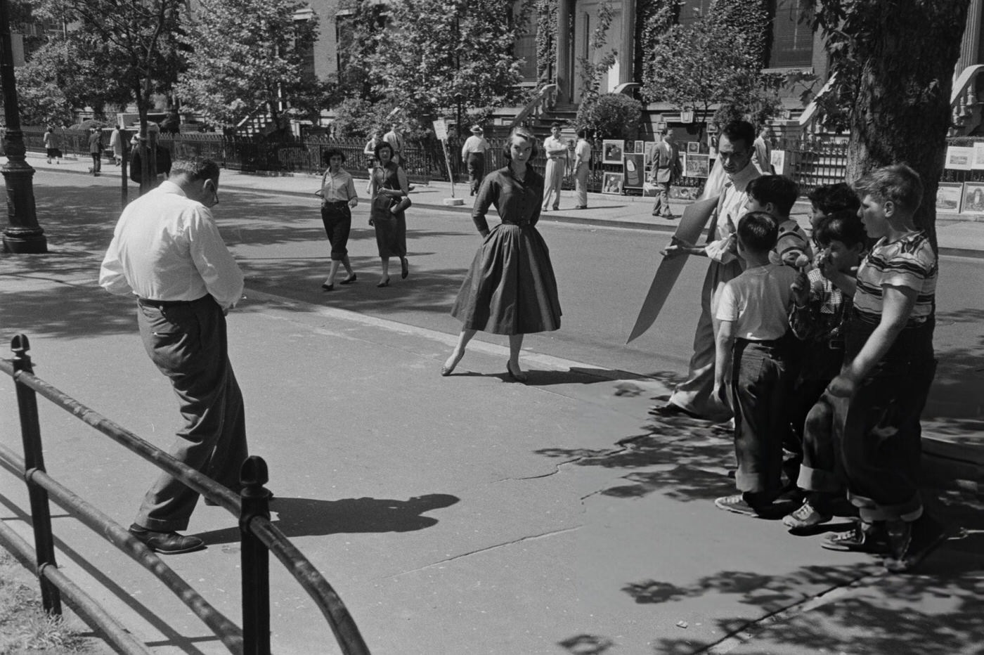 A young woman posing for a photographer at an outdoor art show in Greenwich Village, 1952.